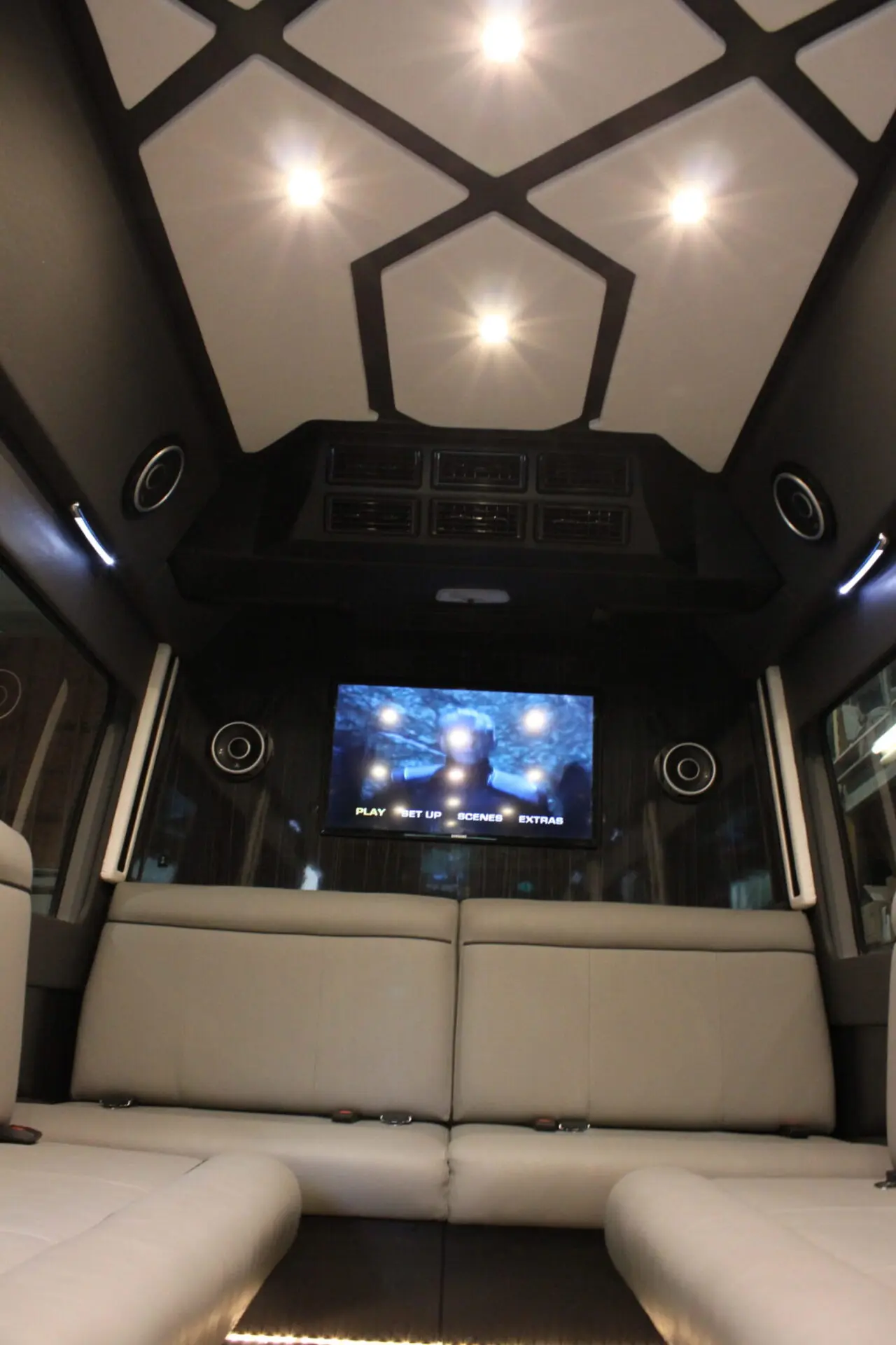 a space in a van with TV and couch for sitting